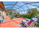 Relaxing screened pool with lounge chairs, manicured landscaping, and tranquil outdoor space at 107 Wayforest Dr, Venice, FL 34292