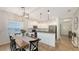Kitchen and dining area with modern lighting fixtures, stainless appliances, and open to the living space at 11111 Encanto Ter, Bradenton, FL 34211