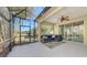 Relaxing screened lanai with a ceiling fan, stylish furniture and view of the backyard at 11111 Encanto Ter, Bradenton, FL 34211