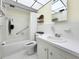 Bathroom features white tiles, a shower, and a vanity with clean lines at 11251 80Th Ave # 305, Seminole, FL 33772