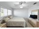 Well-lit bedroom with dresser, ceiling fan, large window, and neutral tones for a relaxing atmosphere at 11251 80Th Ave # 305, Seminole, FL 33772