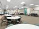 Spacious common room featuring tables, chairs, and ample space for gatherings and events at 11251 80Th Ave # 305, Seminole, FL 33772