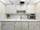 Bright kitchen with white countertop, ample storage, sink, and essential appliances including a toaster oven at 11251 80Th Ave # 305, Seminole, FL 33772