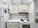 Bright kitchen featuring white appliances, ample storage, and a clean, functional layout at 11251 80Th Ave # 305, Seminole, FL 33772