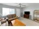 Comfortable living room featuring a ceiling fan, television, and ample seating at 11251 80Th Ave # 305, Seminole, FL 33772