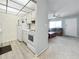 Bright condo with spacious living room, cozy sofa, and adjoining kitchen with white appliances at 11251 80Th Ave # 305, Seminole, FL 33772