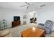 Open living space with comfortable seating, a ceiling fan, and a view into the office at 11251 80Th Ave # 305, Seminole, FL 33772