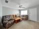 Inviting living room with neutral tones, ceiling fan, and comfortable seating arrangement at 11251 80Th Ave # 305, Seminole, FL 33772