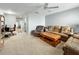 Spacious living area with a ceiling fan, comfortable seating, and an adjacent office space at 11251 80Th Ave # 305, Seminole, FL 33772