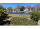 Scenic view of a serene pond with a fountain, lush greenery, and a glimpse of the condos in the background at 11251 80Th Ave # 305, Seminole, FL 33772