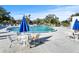 Community pool with ample seating and tables around a sparkling, inviting pool area at 11251 80Th Ave # 305, Seminole, FL 33772