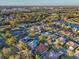 Aerial view of a neighborhood near a lake, showcasing single-Gathering homes and lush landscaping at 11835 Hollyhock Dr, Lakewood Ranch, FL 34202