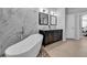 Modern bathroom featuring a soaking tub, dual vanity, and marble accents at 11835 Hollyhock Dr, Lakewood Ranch, FL 34202
