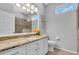 Bathroom with granite countertops, decorative mirror, vanity, and a tiled walk-in shower at 11835 Hollyhock Dr, Lakewood Ranch, FL 34202