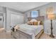 Cozy bedroom features a comfortable queen bed, soft, neutral tones, and natural light from the window at 11835 Hollyhock Dr, Lakewood Ranch, FL 34202
