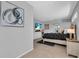 Bedroom with a wall-mounted television and modern decor with an archway leading to another room at 11835 Hollyhock Dr, Lakewood Ranch, FL 34202