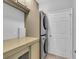 Well-lit laundry room with stacked washer and dryer and ample storage at 11835 Hollyhock Dr, Lakewood Ranch, FL 34202