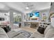 Open living room features a fireplace and sliding glass doors leading to the pool at 11835 Hollyhock Dr, Lakewood Ranch, FL 34202