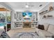 Cozy living room featuring a fireplace and views of the outdoor pool and patio area at 11835 Hollyhock Dr, Lakewood Ranch, FL 34202