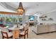 Bright living room with a fireplace, chandelier, and sliding glass doors to a screened pool at 11835 Hollyhock Dr, Lakewood Ranch, FL 34202