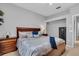 Comfortable main bedroom with a wooden bed frame and an interior gun safe at 11835 Hollyhock Dr, Lakewood Ranch, FL 34202