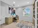 Home office with built-in shelving, natural light, and neutral decor. Perfect workspace at 11835 Hollyhock Dr, Lakewood Ranch, FL 34202