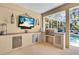 Outdoor kitchen featuring stainless steel grill and bar area at 11835 Hollyhock Dr, Lakewood Ranch, FL 34202