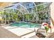 Screened-in pool area with lush landscaping providing privacy and shade at 11835 Hollyhock Dr, Lakewood Ranch, FL 34202