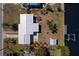 Aerial perspective of property highlighting landscaping, waterfront access, dock, shed, and a well-kept lawn at 125 Palmetto Ne Cir, Port Charlotte, FL 33952
