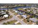 Aerial view of a waterfront neighborhood featuring houses on canals with easy access to the bay at 125 Palmetto Ne Cir, Port Charlotte, FL 33952