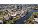 Aerial view showcasing the neighborhood, canals, waterfront access, and boat docks at this home at 125 Palmetto Ne Cir, Port Charlotte, FL 33952