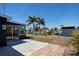 Picturesque backyard with tropical landscaping, featuring waterfront views and a charming patio area at 125 Palmetto Ne Cir, Port Charlotte, FL 33952