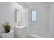Neat bathroom with shower and tub combination, featuring tiled walls, and a vanity sink at 125 Palmetto Ne Cir, Port Charlotte, FL 33952