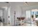 Bright dining area features tile flooring, white accents, a breakfast table, and a sliding door at 125 Palmetto Ne Cir, Port Charlotte, FL 33952