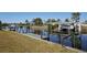 Scenic waterfront view with a private dock, boat lift, and canal access for boating and enjoying the water at 125 Palmetto Ne Cir, Port Charlotte, FL 33952