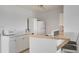 Clean kitchen featuring white appliances, white cabinets, and a breakfast bar with seating at 125 Palmetto Ne Cir, Port Charlotte, FL 33952