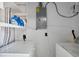 Functional laundry room with washer, dryer, and shelf at 125 Palmetto Ne Cir, Port Charlotte, FL 33952