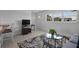 Cozy living room space featuring contemporary décor, comfortable seating, and bright natural light from large windows at 125 Palmetto Ne Cir, Port Charlotte, FL 33952
