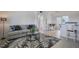 Bright living room with modern decor, a stylish rug, and comfortable seating that leads to a cozy dining area at 125 Palmetto Ne Cir, Port Charlotte, FL 33952