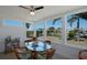 Inviting sunroom featuring canal views, chic furniture, and a delightful dining setting at 125 Palmetto Ne Cir, Port Charlotte, FL 33952