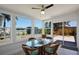 Bright sunroom with canal views, stylish furniture, and an inviting dining space at 125 Palmetto Ne Cir, Port Charlotte, FL 33952