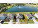 Beautiful single-Gathering home featuring lush green landscaping and a serene lake view at 12533 Night View Dr, Sarasota, FL 34238