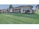 Backyard with lush green grass and a covered patio, perfect for relaxing and enjoying the outdoors at 17907 Palmiste Dr, Bradenton, FL 34202