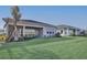 Spacious backyard with lush green grass and a covered patio, perfect for outdoor entertaining and relaxation at 17907 Palmiste Dr, Bradenton, FL 34202