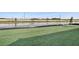 A spacious backyard with lush green grass and a view of the serene lake beyond at 17907 Palmiste Dr, Bradenton, FL 34202