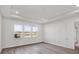 Bright bedroom featuring wood flooring, three large windows and tray ceiling at 17907 Palmiste Dr, Bradenton, FL 34202