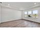 Well-lit bedroom featuring wood floors, a tray ceiling and three large windows at 17907 Palmiste Dr, Bradenton, FL 34202