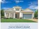 Inviting Carver Island Colonial featuring a 2-car garage, manicured lawn, and stylish architectural details at 17907 Palmiste Dr, Bradenton, FL 34202