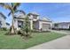 A charming single-Gathering home boasts lush landscaping, a paver driveway, and a convenient two-car garage at 17907 Palmiste Dr, Bradenton, FL 34202
