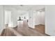 Bright hallway with wood flooring, white trim, and open doorways showing spacious floorplan at 17907 Palmiste Dr, Bradenton, FL 34202